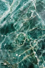 Green marble surface texture close-up. Rough green stone with white specks. Above view of intricate details. Perfect background for design, art, or tech projects.