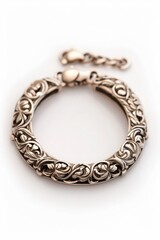 Obraz premium Elegant silver bracelet with intricate floral patterns, perfect for adding a touch of sophistication to any outfit.