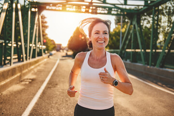 great sporty woman jogging outdoors on sunset time