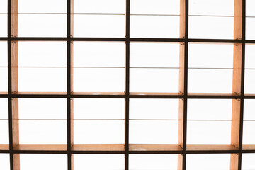 Geometric interior. Roof background. Glass ceiling texture. Wooden construction. Wood architecture. Bright white light.