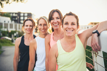 females in sportswear jogging together bright sunny park in summer