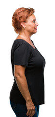 Atrractive senior caucasian redhead woman over isolated background looking to side, relax profile pose with natural face with confident smile.