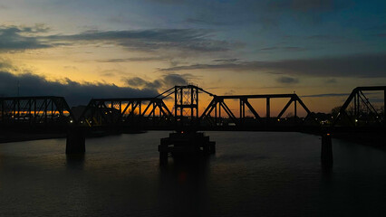 Fototapeta premium bridge over a river at sunset