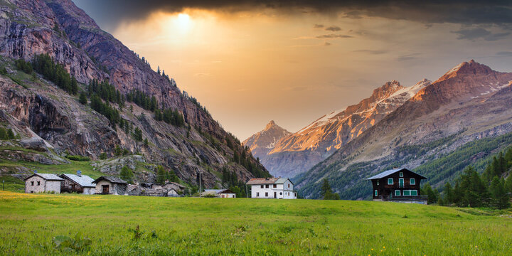 Traditional alpine village in Italian Alps at sunset, Valsavarenche, Gran Paradiso Park, Aosta Valley, Italy
