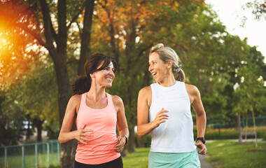Two athletic women in sportswear is jogging together