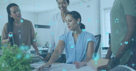 Image of network of digital icons over diverse colleagues discussing together at office