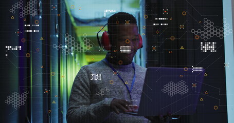 Image of data processing over african american male engineer using laptop at server room