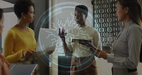 Image of cyber security text and security padlock icon over diverse women discussing at office