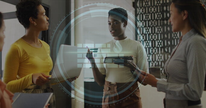 Image of cyber security text and firewall icon over diverse women discussing together at office