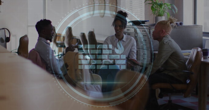 Image of cyber security text and firewall icon over diverse colleagues discussing at office - Powered by Adobe