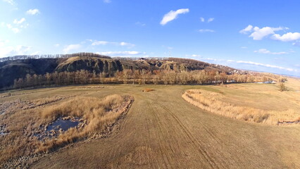The photo shows a natural landscape - land, lakes, rivers, trees and meadow. Filming from a quadcopter.