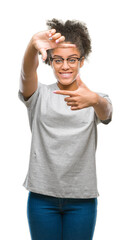 Young afro american woman wearing glasses over isolated background smiling making frame with hands and fingers with happy face. Creativity and photography concept.