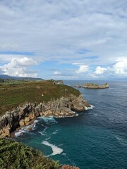 Green grassy coastline on a sunny day in Asturias, Spain
