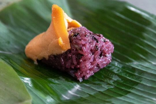 Black sticky rice with Thai custard (Khao Nieaw Sang Ka Ya) The local store normally put a slice of custard on topped of the rice and then wrapped them up in banana leaf.