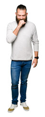 Young blond man wearing casual sweater feeling unwell and coughing as symptom for cold or bronchitis. Healthcare concept.