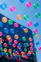 People walk along the shopping street called Meritxell decorated with colorful balls in the capital Andorra la Vella, Andorra in 2024.