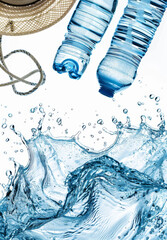 Summer heat danger concept. Water splashes, fan, hat, ice cubes and bottled water