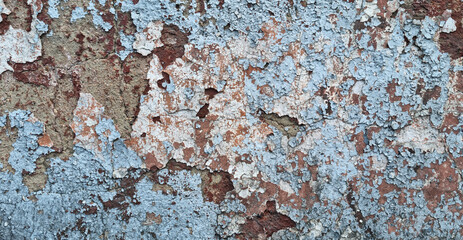 Texture of old rustic wall covered with gray and blue stucco. Multilayers of old paint on the wall....