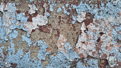 Texture of old rustic wall covered with gray and blue stucco. Multilayers of old paint on the wall. Textured background. Selective focus