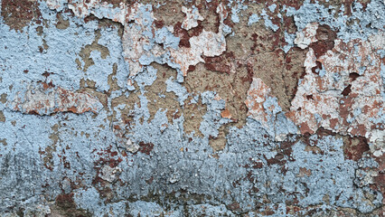 Texture of old rustic wall covered with gray and blue stucco. Multilayers of old paint on the wall....
