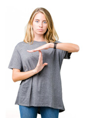 Beautiful young woman wearing oversize casual t-shirt over isolated background Doing time out...