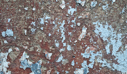 Texture of old rustic wall covered with gray and blue stucco. Multilayers of old paint on the wall....