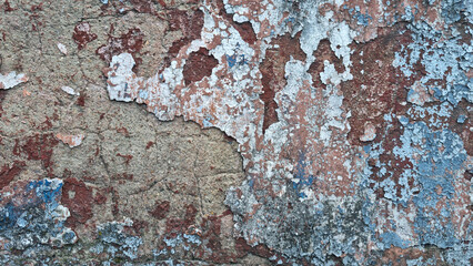 Texture of old rustic wall covered with gray and blue stucco. Multilayers of old paint on the wall. Textured background. Selective focus