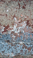 Texture of old rustic wall covered with gray and blue stucco. Multilayers of old paint on the wall. Textured background. Selective focus