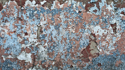 Texture of old rustic wall covered with gray and blue stucco. Multilayers of old paint on the wall. Textured background. Selective focus