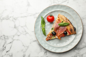 Tasty pizza with cured ham, olives, tomato and basil on white marble table, top view. Space for text