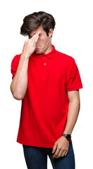 Young handsome man wearing red t-shirt over isolated background smelling something stinky and...