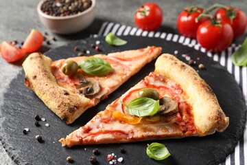 Cut delicious vegetarian pizza, spices and tomatoes on table
