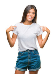 Young asian woman over isolated background looking confident with smile on face, pointing oneself with fingers proud and happy.