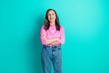 Photo of adorable lovely woman wear pink shirt arms crossed empty space isolated blue color background