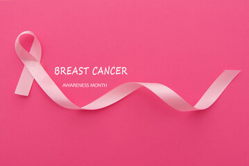 text breast cancer awareness with waving ribbon on pink background