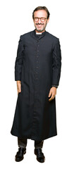Middle age priest man wearing catholic robe winking looking at the camera with sexy expression,...