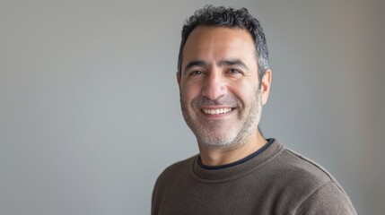 Friendly Middle Aged Man Smiling, Middle Eastern, Casual Attire, Gray Background, Portrait for Professional and Personal Use
