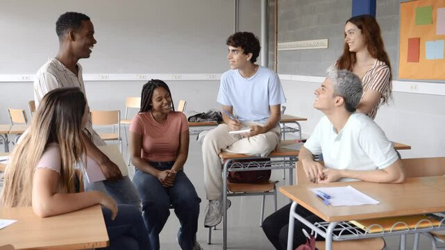 Group of multi-ethnic students talking in class during a break. High school, back to school, diverse students 
