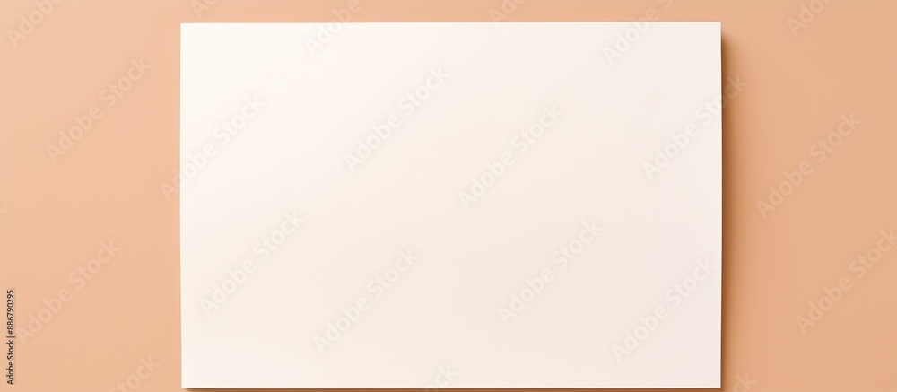 Fototapete Overhead view of a blank white paper on a beige background with copy space image.