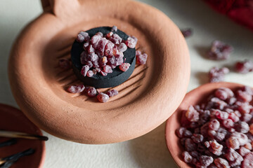 Red resin incense at clay censer.