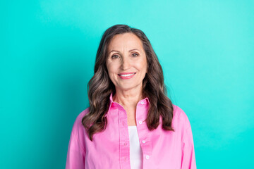 Photo of charming positive woman wear pink shirt smiling empty space isolated blue color background
