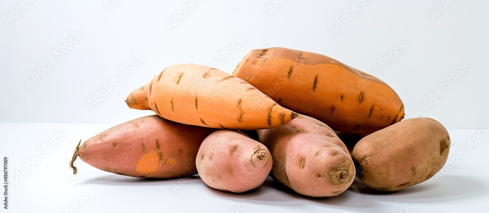 Poster isolated on the white backdrop, a fresh sweet potato is displayed with a clear area providing room f