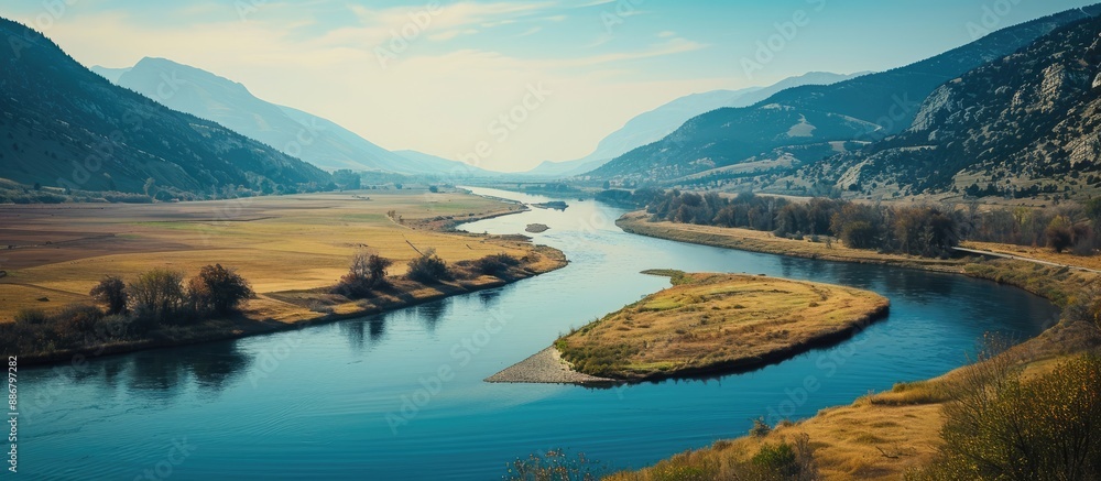 Poster A river meandering with a scenic view on one side and a vast and appealing blank space to be used for display or advertisement on the other side.