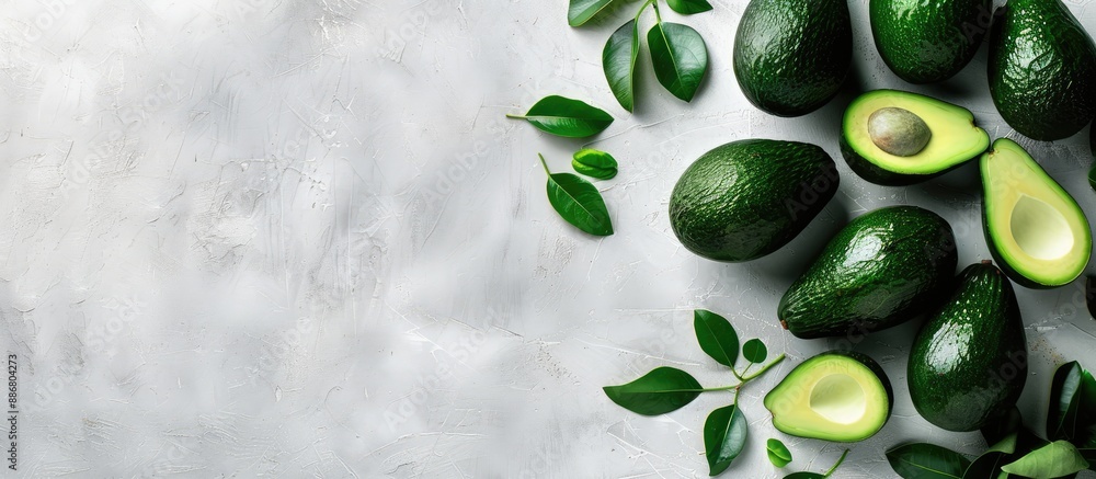 Aufkleber Whole and sliced ripe avocados displayed from the top view on a white backdrop with ample copy space image.