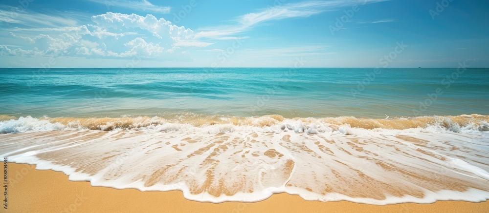 Poster Ocean waves gently lapping the sandy shore create a calming scene with a breathtaking view of the horizon and a clear blue sky in the background with copy space image.