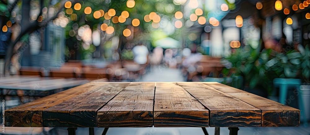 Leinwandbilder a brown table with an empty surface is the focal point of the shot with a blurred coffee shop backgr
