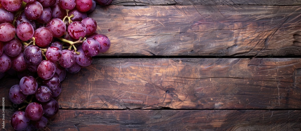 Poster Close-up of grapes on a wooden background with copy space image.