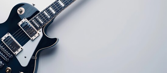 Close-up of an electric guitar on a white backdrop with copy space image.