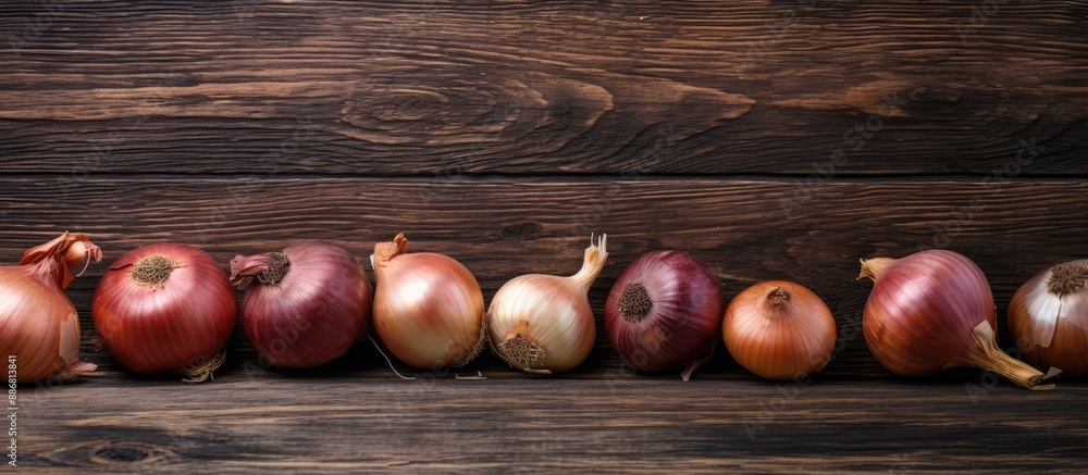 Poster onions arranged on a rustic wooden table with a weathered look, surrounded by a copy space image.