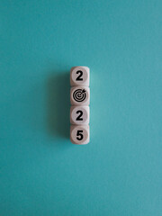 2025 Happy New year symbol. Numbers and target dart icon on white blocks stacked on blue...